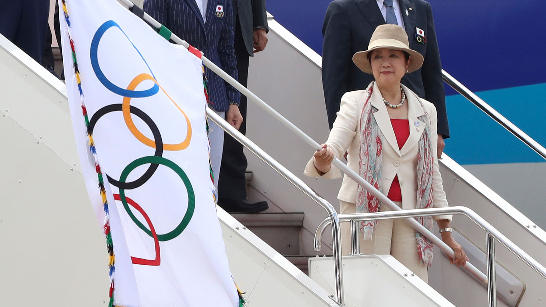  Tokyo Governor Yuriko Koike waves the Olympic flag upon arrival of the flag at Haneda international airport in Tokyo. (Photo: AP)