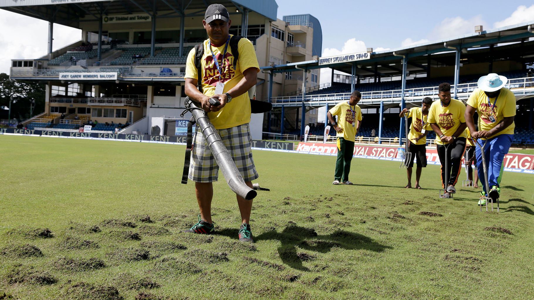  Ground staff dry the outfield as a wet ground delays the start of day three of the fourth cricket Test match between India and West Indies. (Photo: AP)