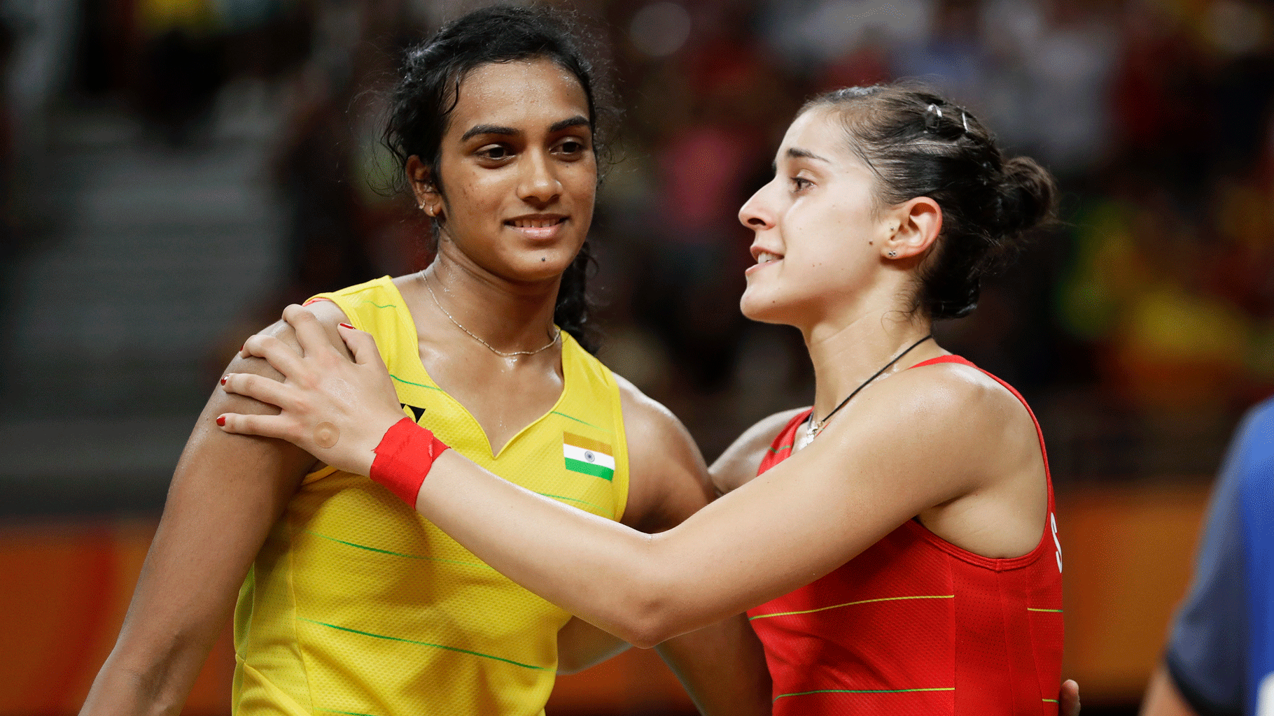  PV Sindhu and Carolina Marin embrace after the Spaniard defeated the Indian to win the women’s singles gold medal at the 2016 Rio Olympics.
