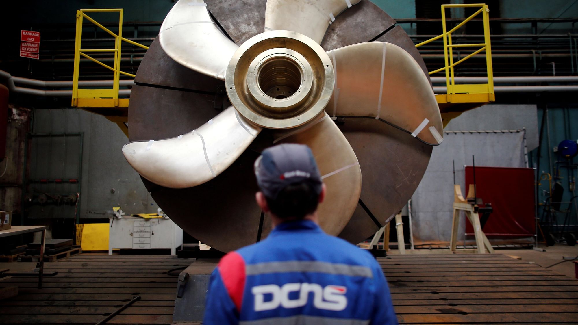 An employee looks at the propeller of a Scorpene submarine at the industrial site of the naval defence company and shipbuilder DCNS in France. (Photo: Reuters)
