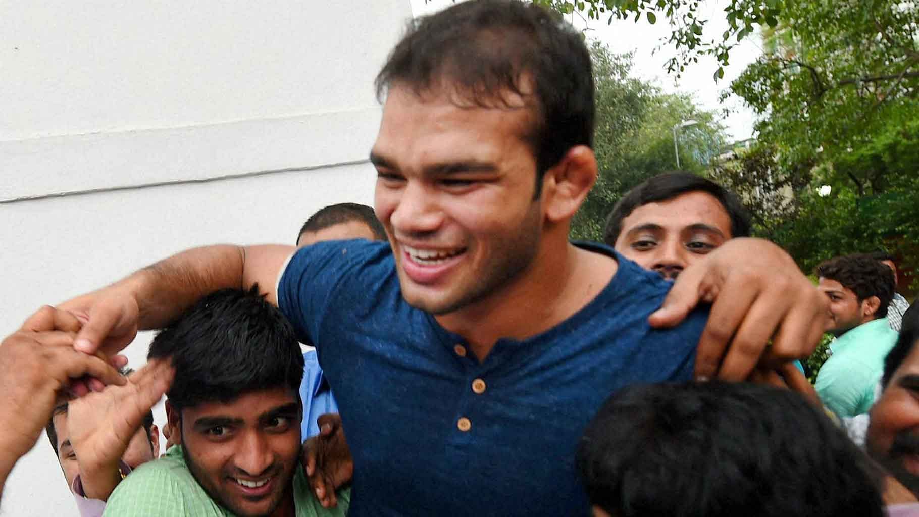 

Supporters lift Wrestler Narsingh Yadav as they celebrate NADA’s clean chit to him on doping charges. (Photo: PTI)