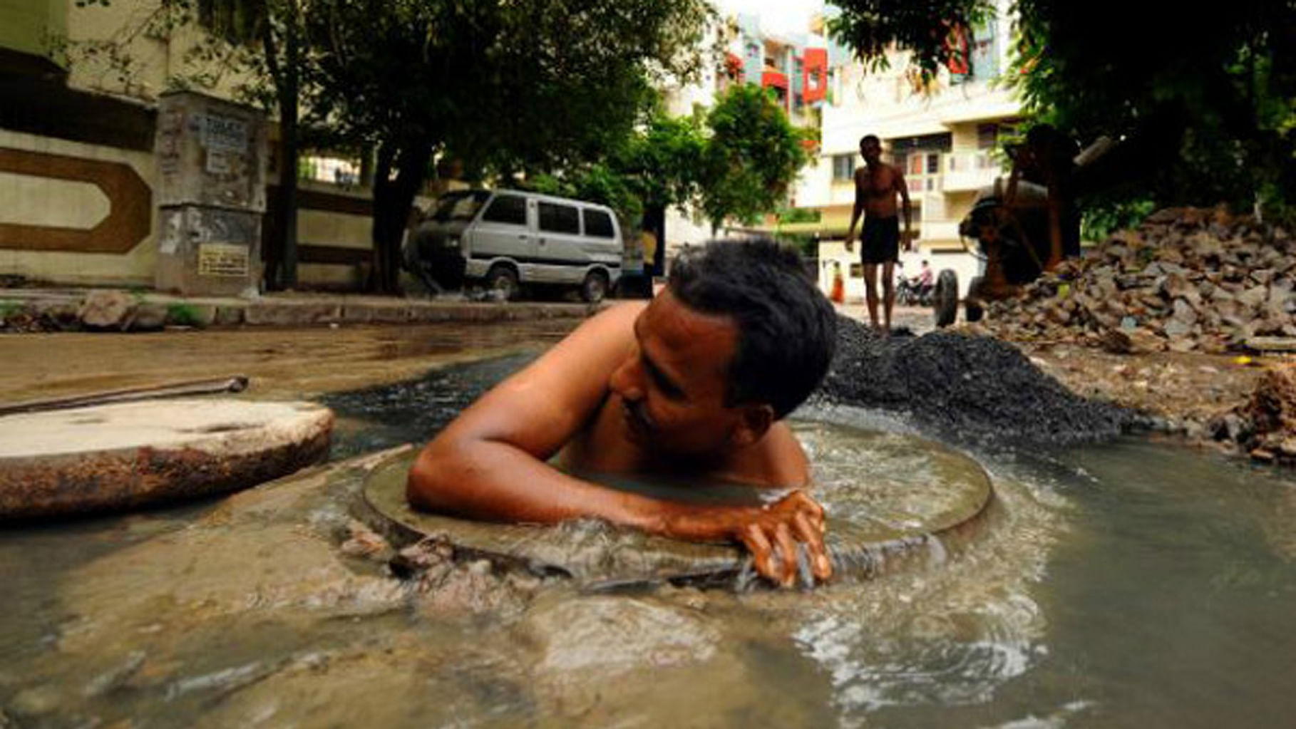 Sanitation workers are forced to work without any protective apparatus. (Photo Courtesy: The News Minute)