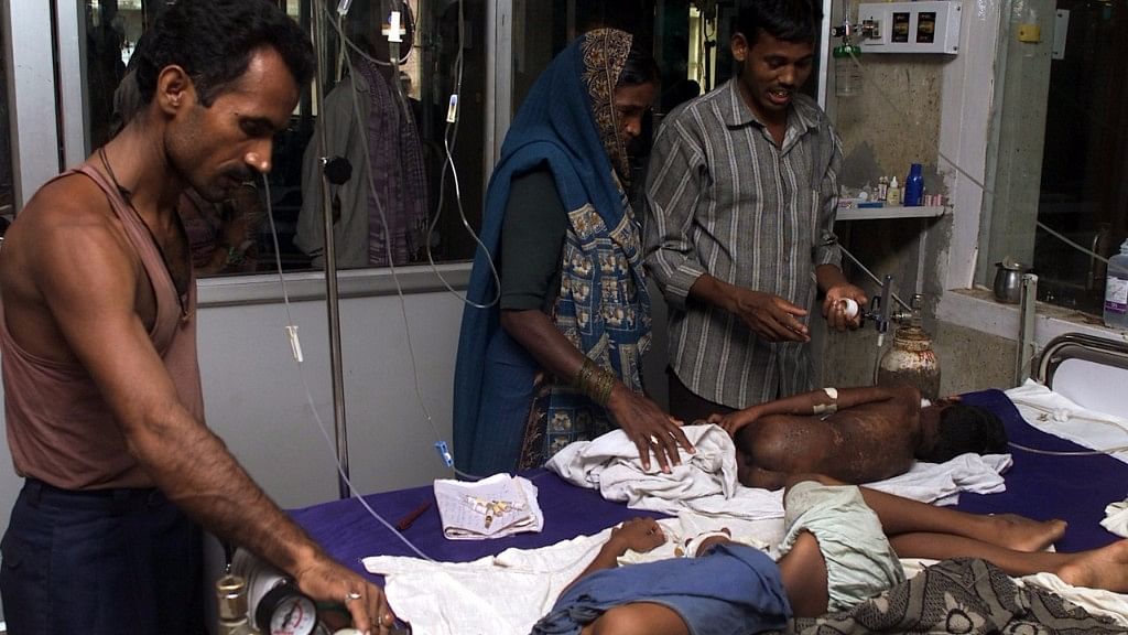 Relatives look after their children at a hospital in Gorakhpur, Uttar Pradesh.&nbsp;