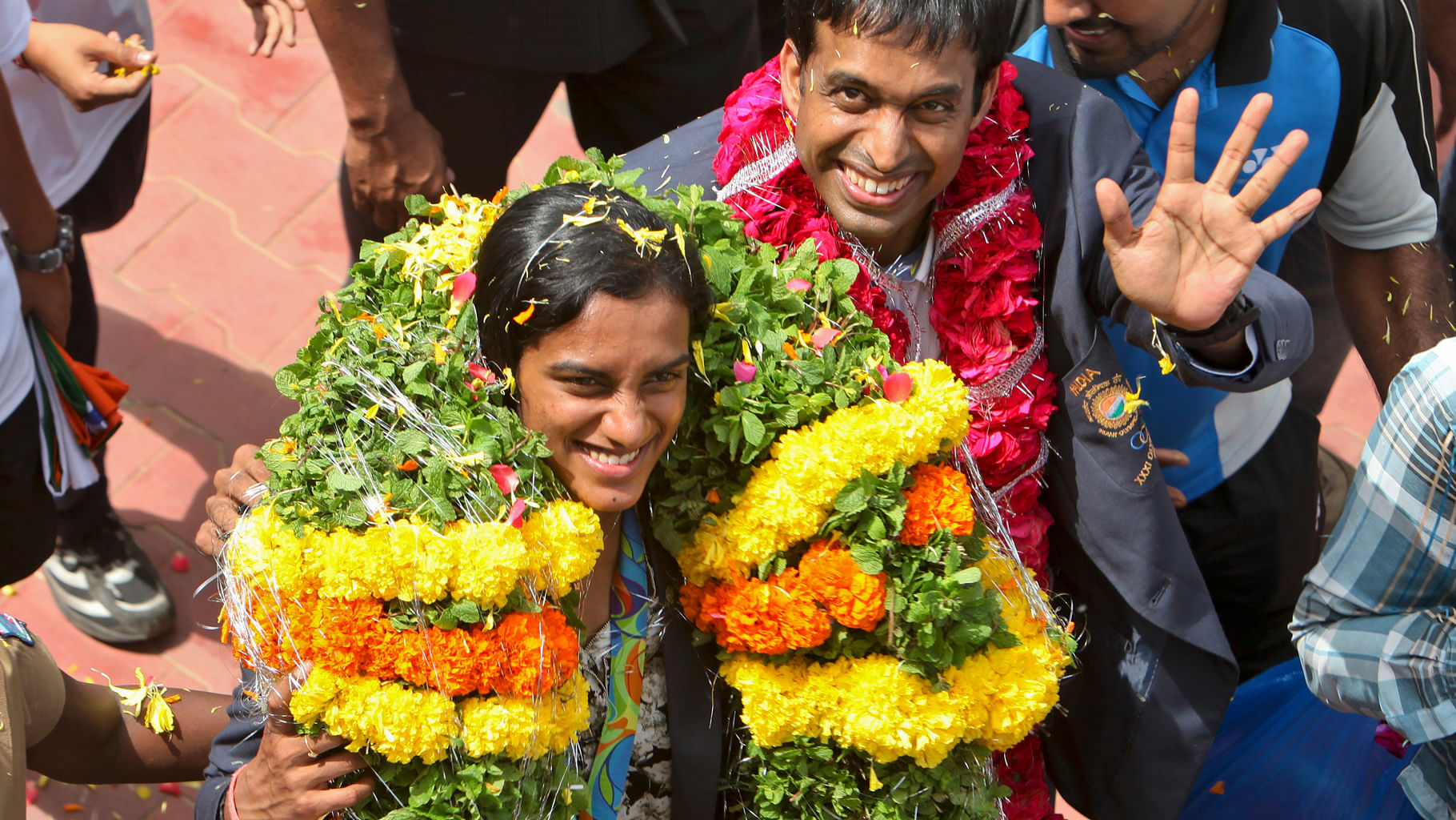 Olympic silver medalist PV Sindhu and her coach Pullela Gopichand wave to the crowd after reaching the Gopichand Academy in Hyderabad. (Photo: AP)