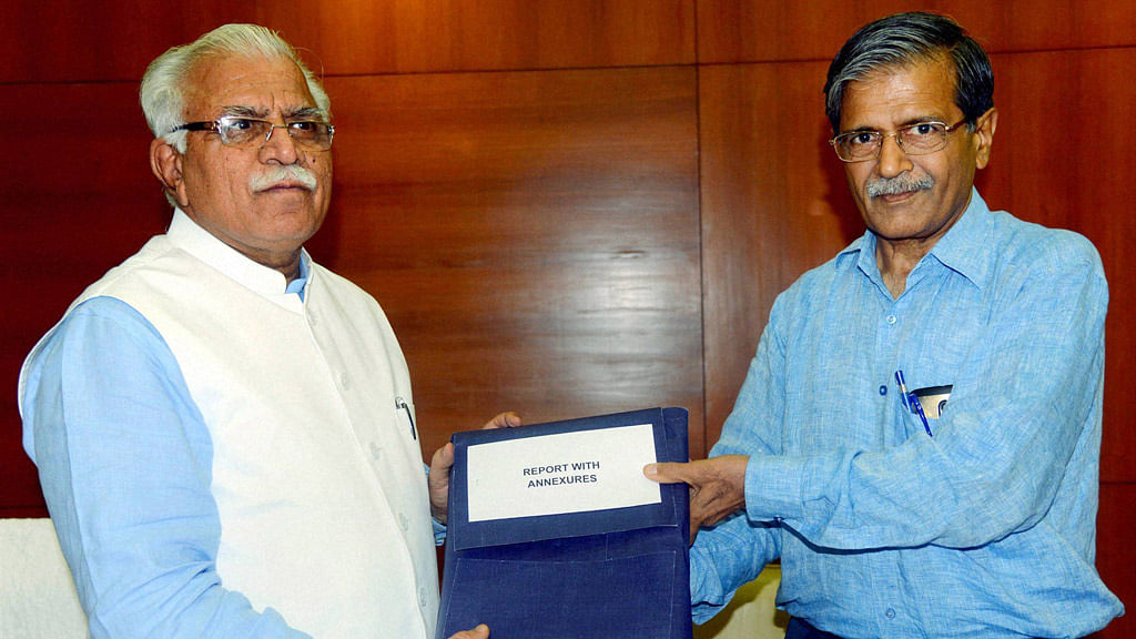 Haryana Chief Minister Manohar Lal Khattar receiving from Justice S N Dhingra the report of the Commission that probed land deals in Gurgaon (including that of Robert Vadra) during Congress rule, in Chandigarh on Wednesday. (Photo Courtesy: PTI)