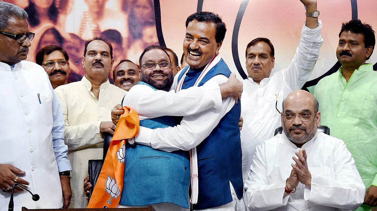 Uttar Pradesh BJP President Keshav Prasad Maurya greets Swami Prasad Maurya in the presence of party president Amit Shah (right) in New Delhi, 8 August, 2016. (Photo: PTI)