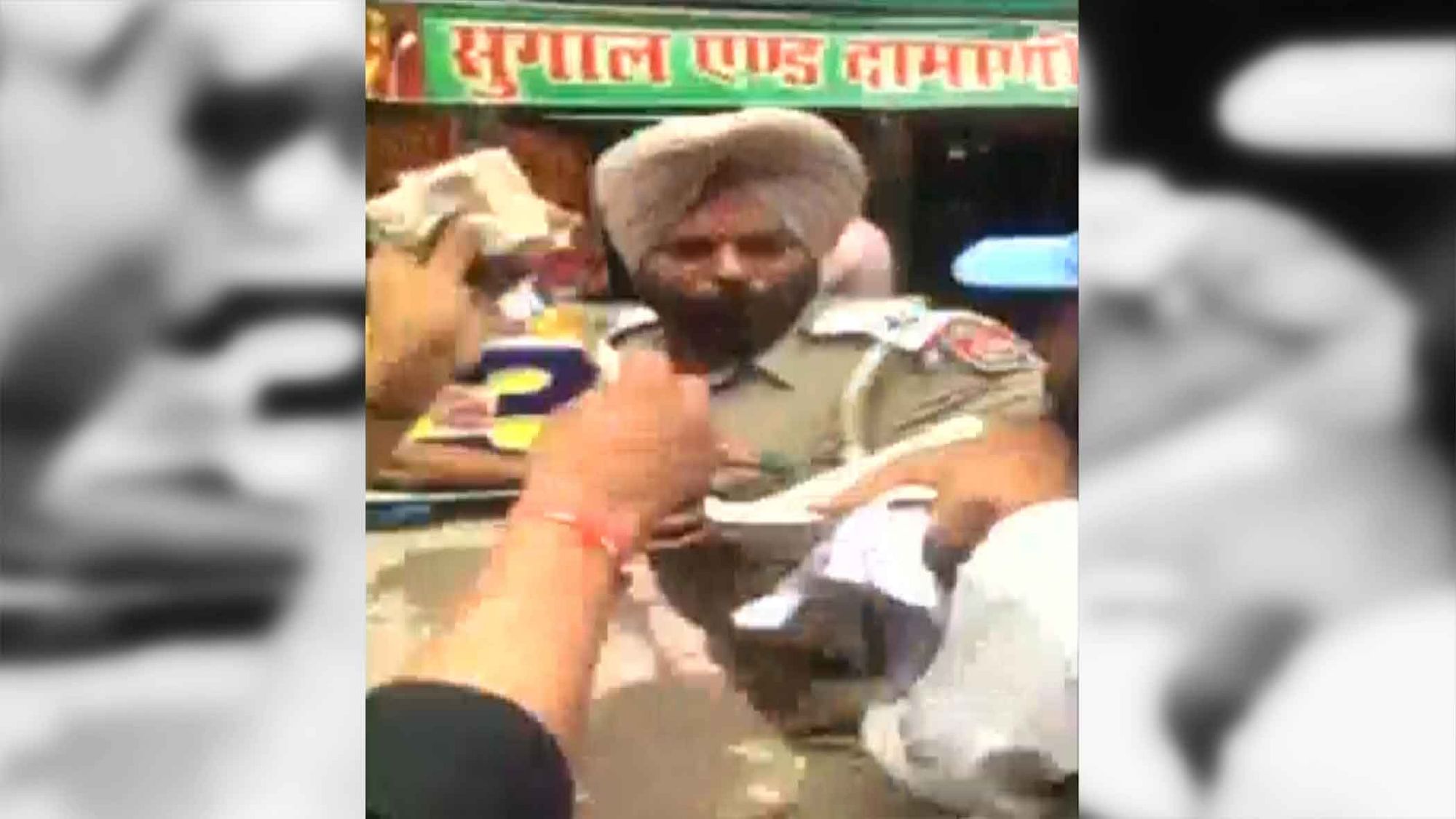 ASI Varinder Singh thrashed for intervening by gambling mafia. (Photo Courtesy: ANI Screengrab) 