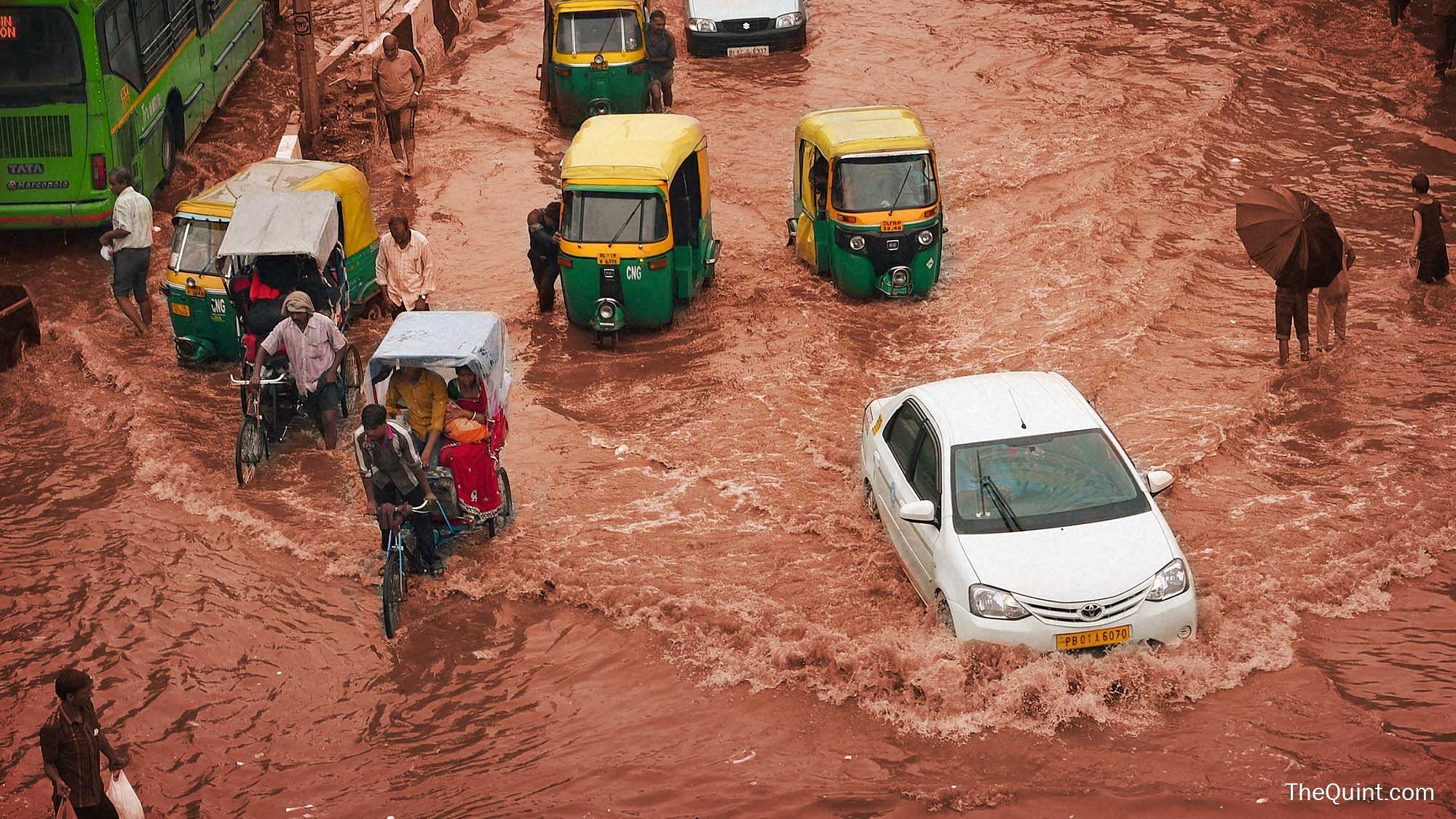 Roads in Delhi flooded with rainwater, July 2015. (Photo: PTI/ Altered by <b>The Quint</b>)