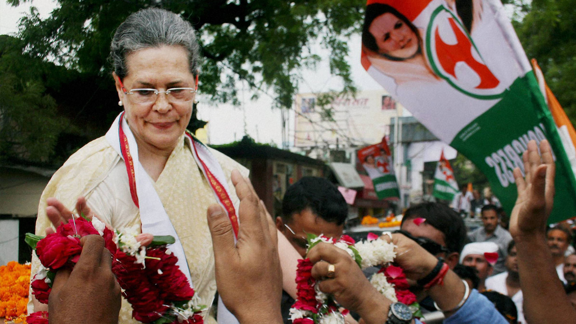 Congress Party President Sonia Gandhi receiving garlands during a road show before she fell ill in Varanasi on Tuesday.&nbsp;