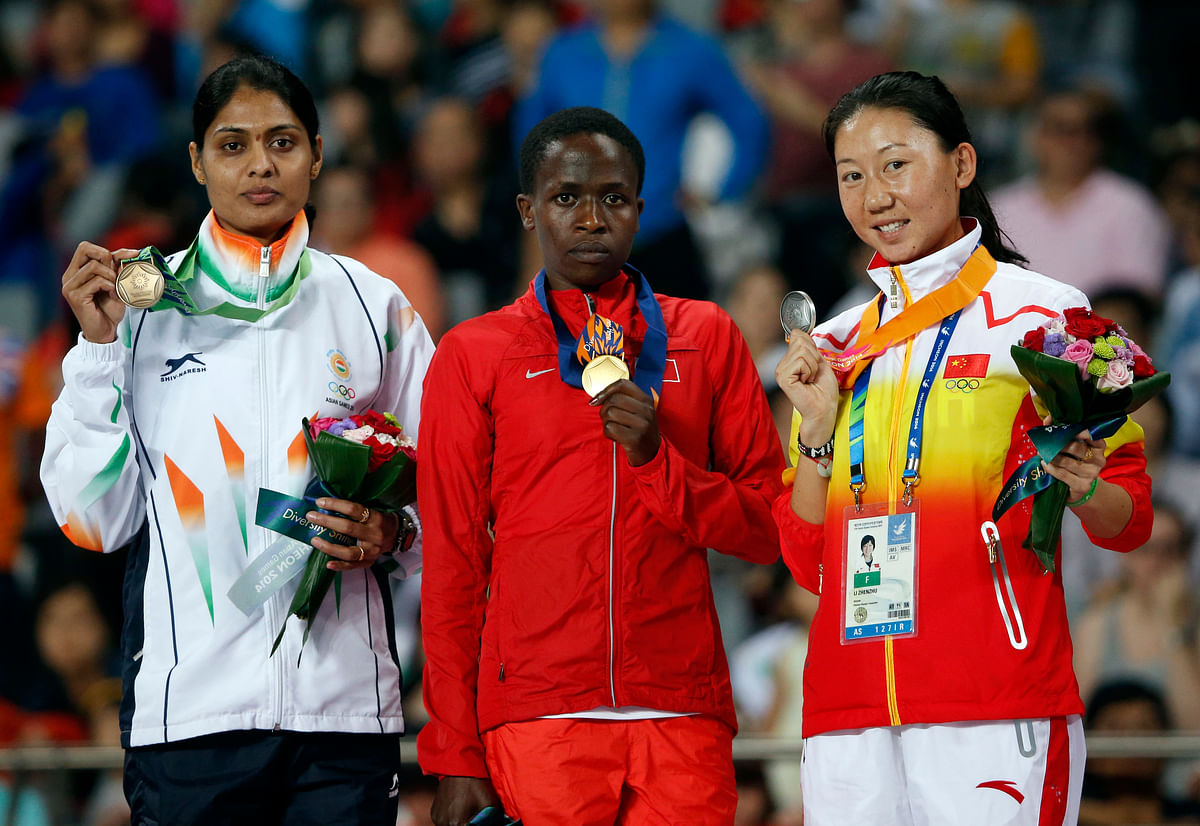 India’s Lalita Babar (L), Bahrain’s Ruth Jebet (C) and China’s Li Zhenzhu (R) with their bronze, gold and silver medals respectively at the Asian Games in 2014. (Photo: Reuters)