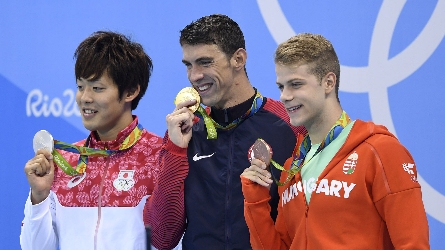 

Gold medalist Michael Phelps (C) of the United States of America  showing his medal during the awarding ceremony for the men’s 200m butterfly final of swimming at the  Rio Olympic Games  9 August, 2016. (Photo: IANS)