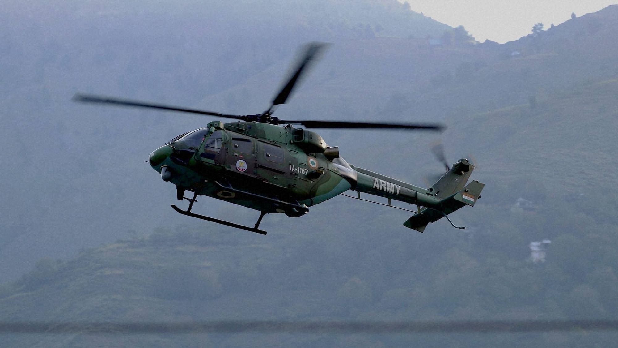 An Indian army helicopter flies above the Army base which was attacked by in the town of Uri, west of Srinagar. (Photo: AP)