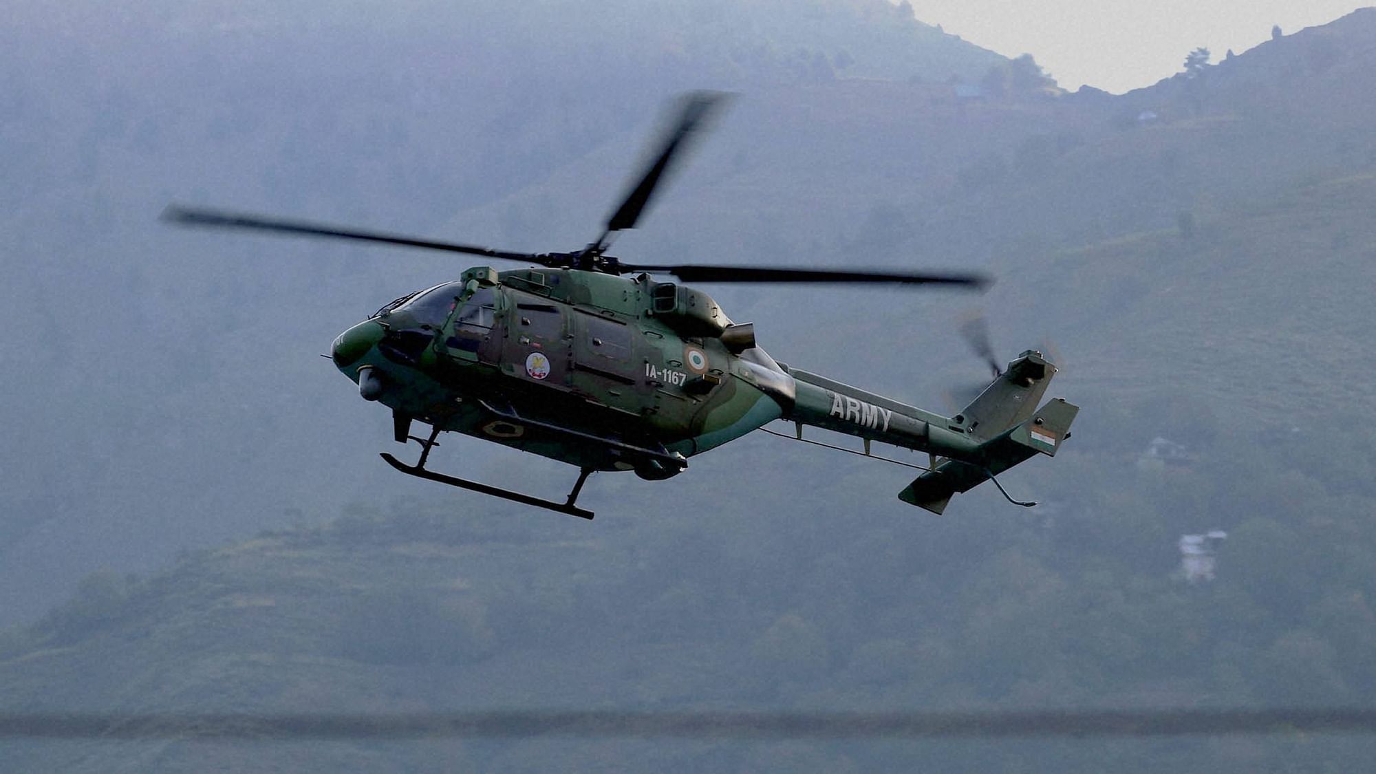 An Indian Army helicopter flies above the Army base which was attacked by suspected militants in the town of Uri, west of Srinagar. (Photo: AP)