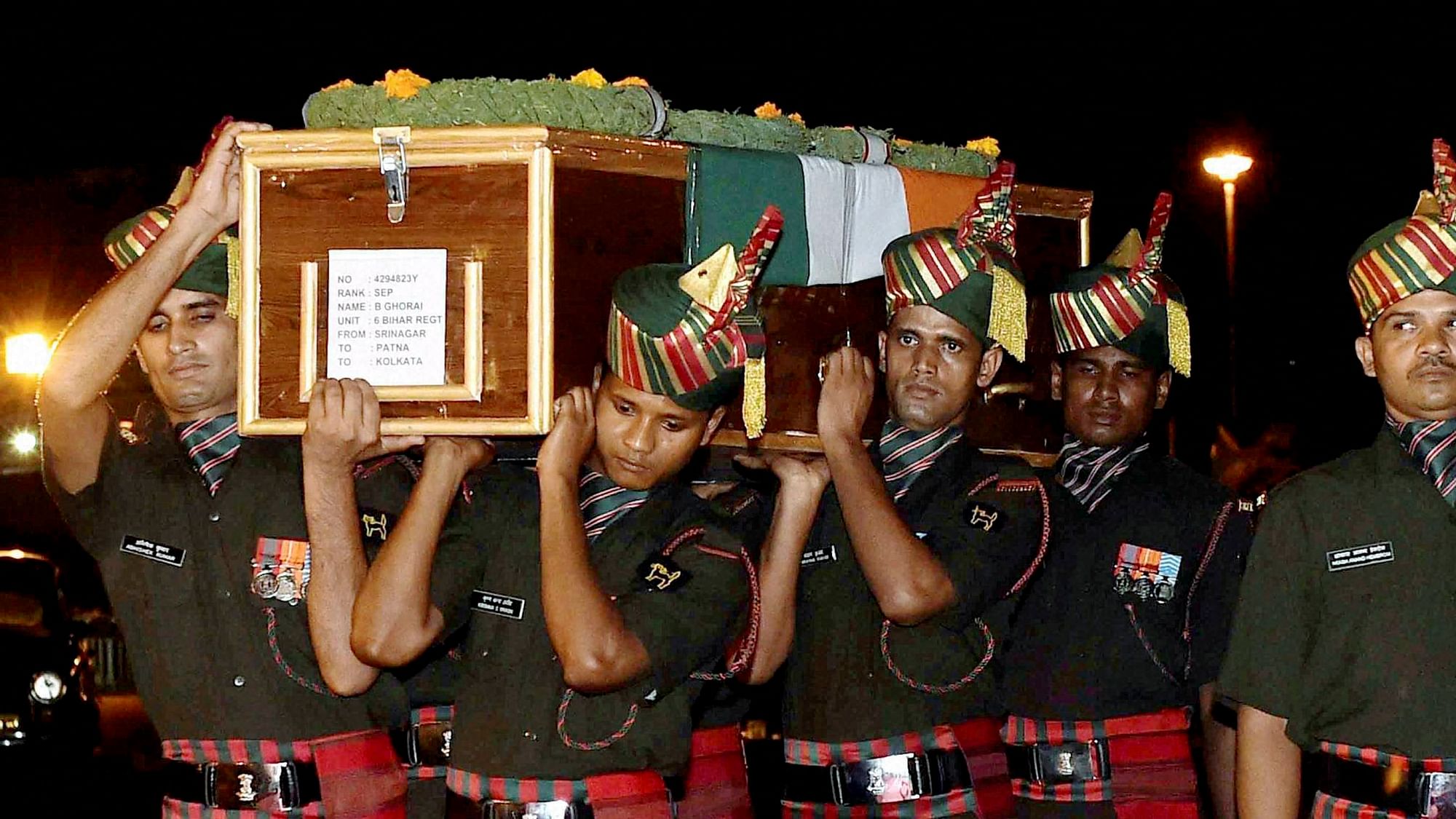 Army jawans carry the body of a martyr killed in the Uri attacks. (Photo: PTI)