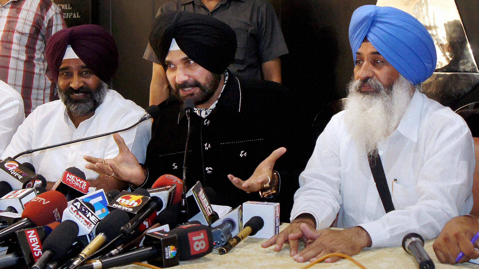 Founder of new front Awaz-e-Punjab Navjot Singh Sidhu with Pargat Singh (L) addresses a press conference in Chandigarh on Thursday. (Photo: PTI)