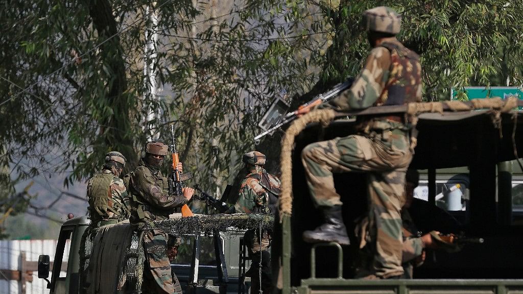 Indian soldiers guard outside the Army base which was attacked on Sunday by suspected militants in Uri. (Photo: AP)