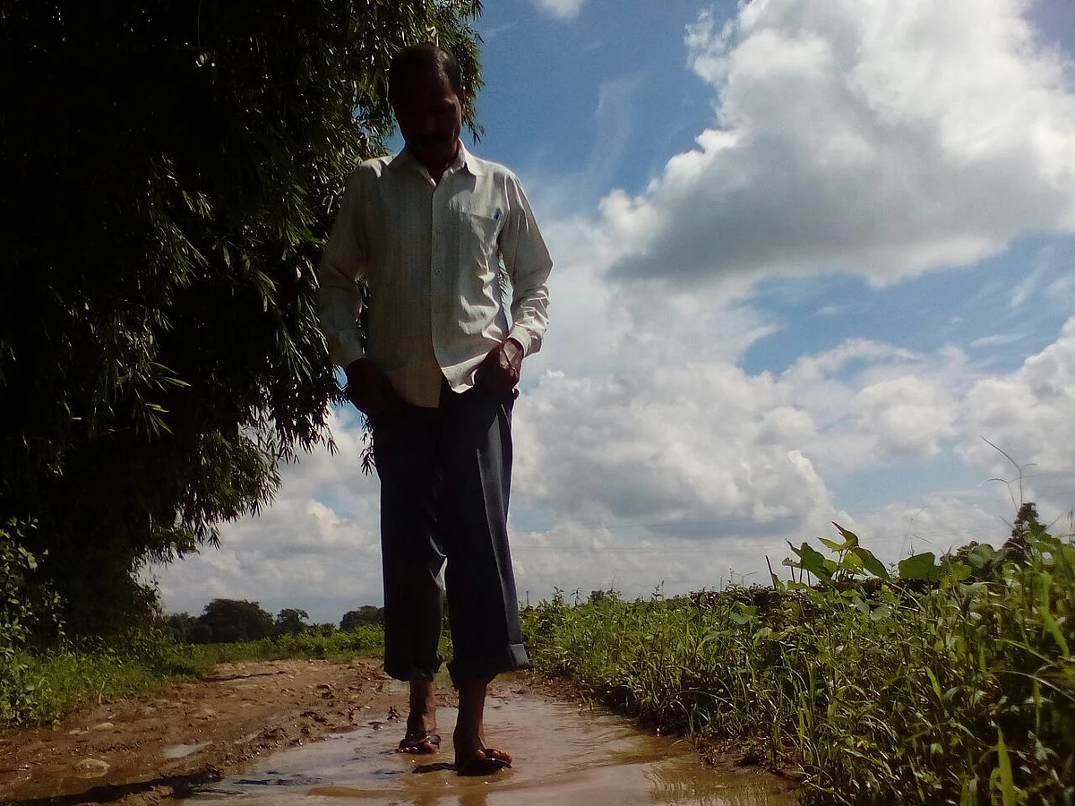 Sukhdeo Pradhan braves the monsoon and floods to come teach his students. (Photo Courtesy: Anjana Dutta)
