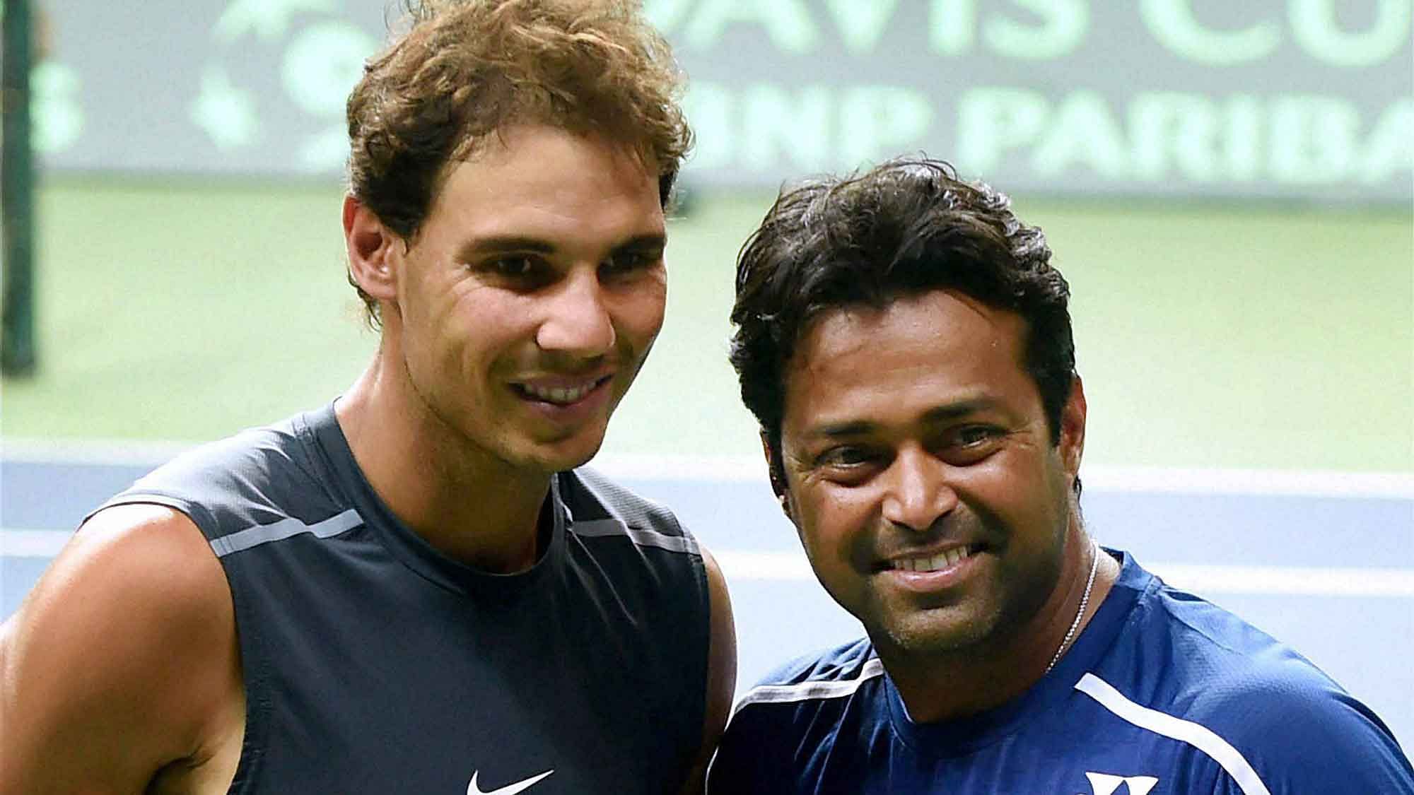 Spain’s Rafael Nadal and India’s Leander Paes pose for photographs during a practice session in New Delhi. (Photo: PTI)