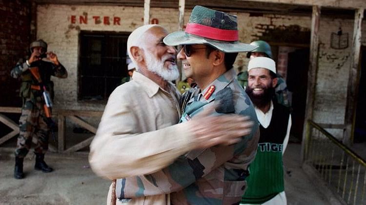 Col Dharmendra Yadav gives ‘Jadoo ki Jhappi’ (magical hug) to a local Imam at Rainpora in Anantnag district during the Operation ‘Calm Down’ of Army in South Kashmir. (Photo: PTI)