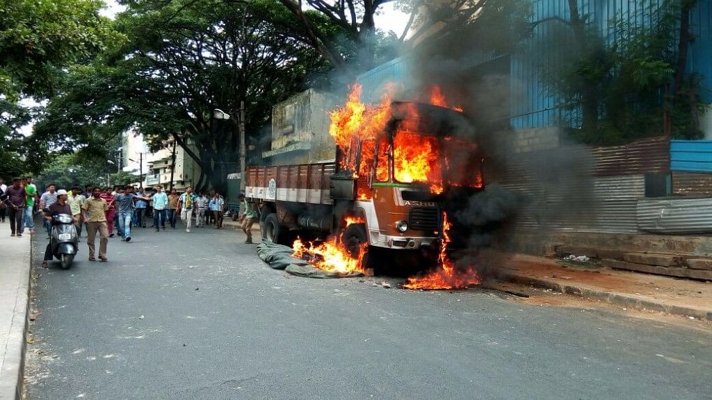 Vehicles with Tamil Nadu numbers were torched and burned by protesters in Bengaluru. (Photo: IANS)