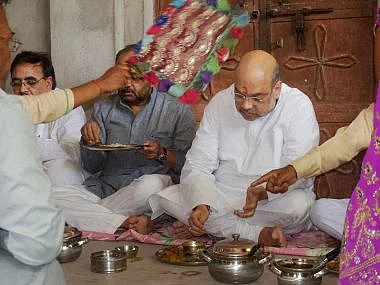 In June, BJP President Amit Shah shared a meal with a Dalit family in Varanasi’s Jogiyapur village. In August he had to cancel a rally in Agra following the ‘Una Chalo!’ march. (Photo: PTI)