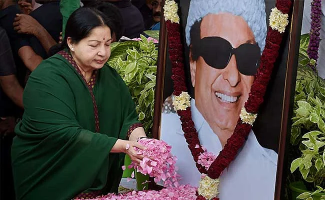 Jayalalithaa offering flowers at the portrait of MG Ramachandran, her film industry colleague and political mentor. (Photo Courtesy: PTI)