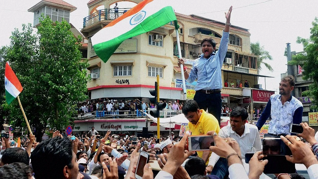 Hardik Patel, convener of the Patidar Anamat Andolan Samiti, leading an agitation in Gujarat. (Photo: PTI)