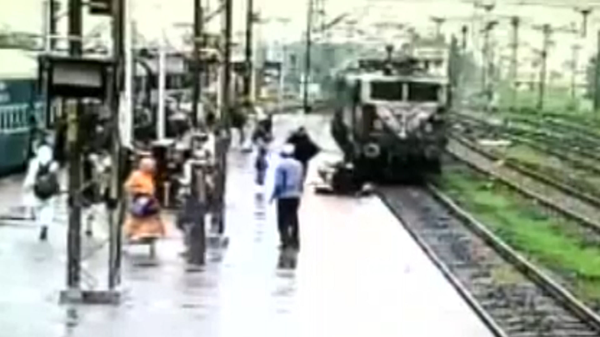 The woman escaped narrowly being hit by the oncoming train at Dahod railway station in Gujarat. (Photo: ANI screengrab)