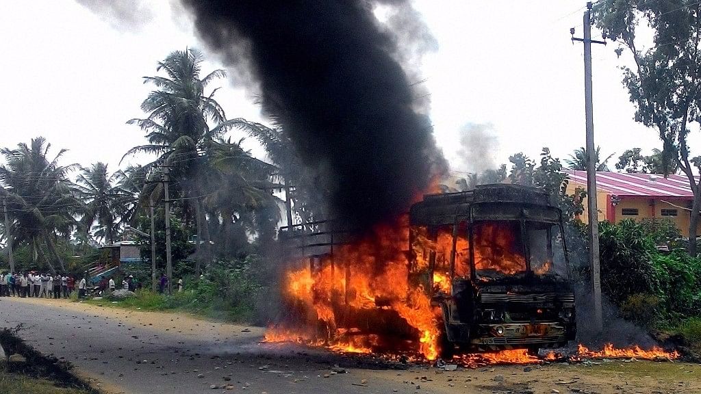 A vehicle in flames after it was torched by Pro-Kannada activists. (Photo: PTI)