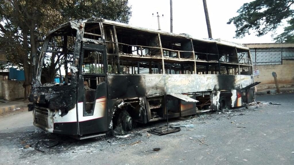 

A bus with Tamil Nadu registration number that was torched by protesters on Bengaluru-Mysuru road on  13 September 2016. (Photo: IANS)