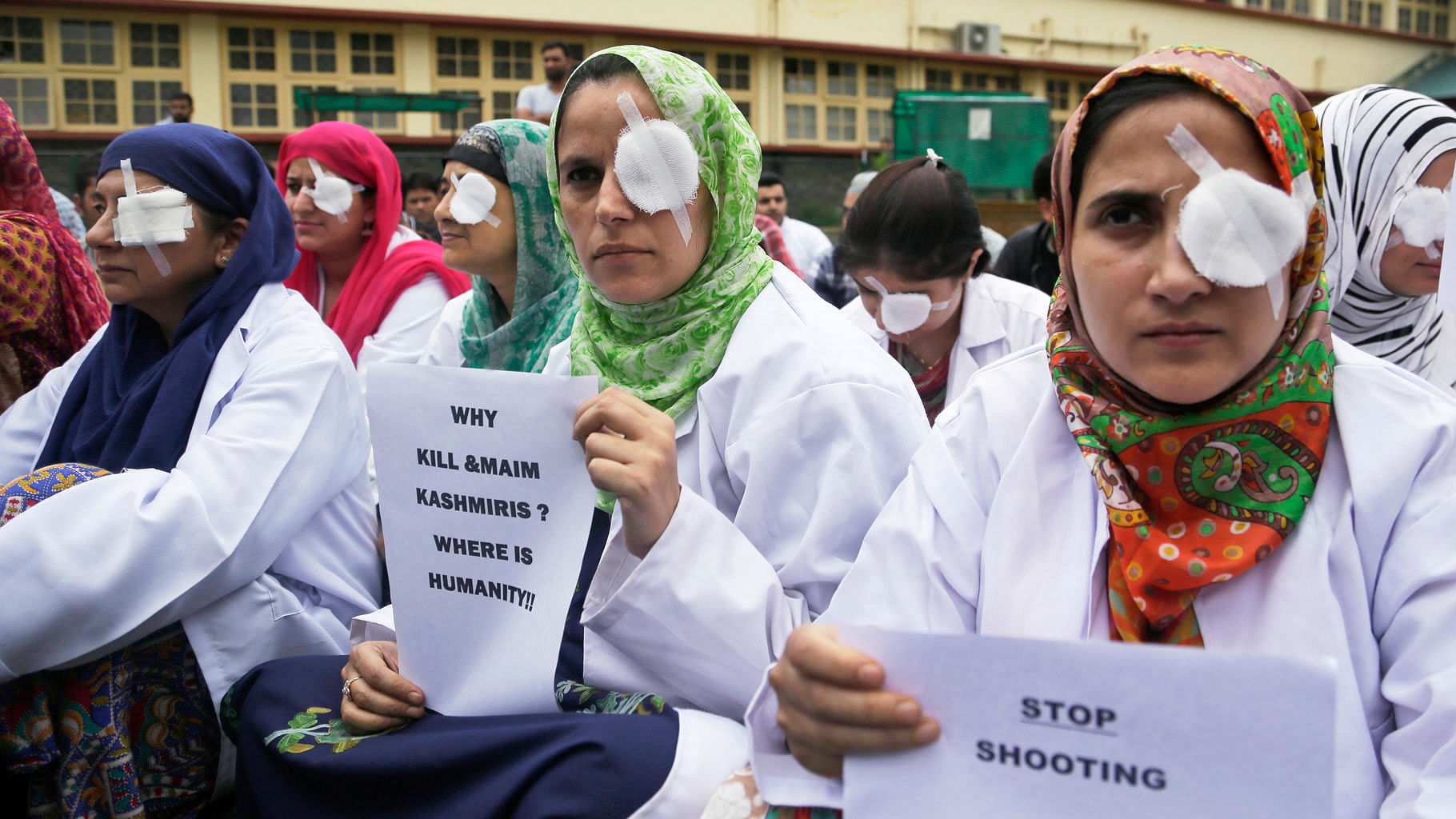 

Kashmiri doctors and medical workers wear bandages on their eyes as a mark of protest against the use of pellet guns and recent killings in Srinagar. (Photo: AP)