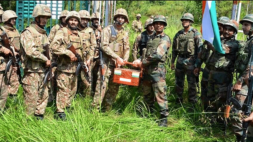 Army representatives of India-Pak exchange sweets at Poonch-Rawalakot Crossing Point in Krishna Ghati. (Photo: ANI)