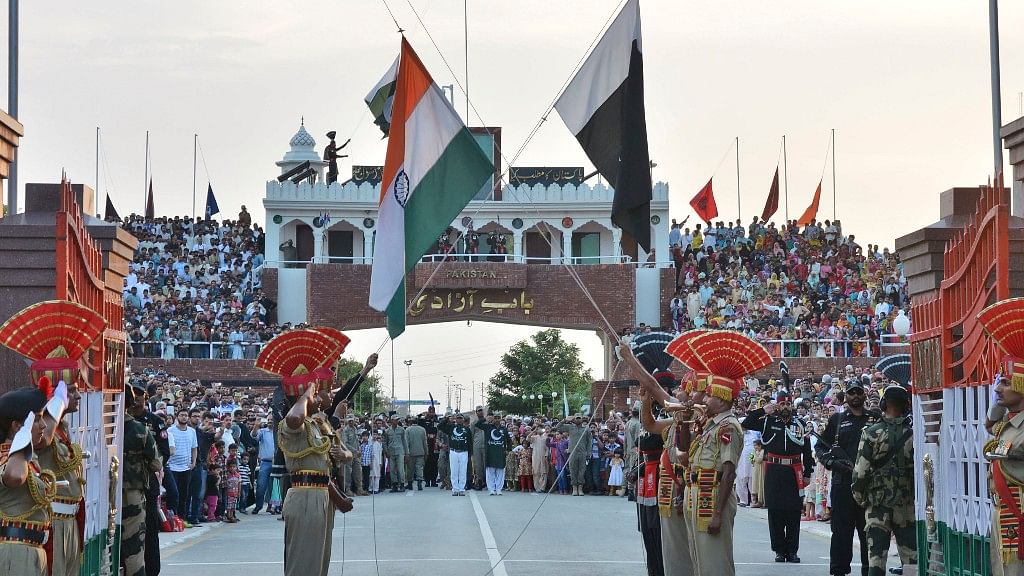 Indian and Pakistani flags are lowered during a daily retreat ceremony at the India-Pakistan joint border check post of Attari-Wagah. (Photo: AP)