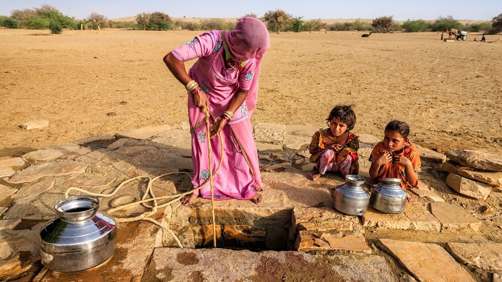 A woman draws water from a well in Rajasthan.&nbsp;