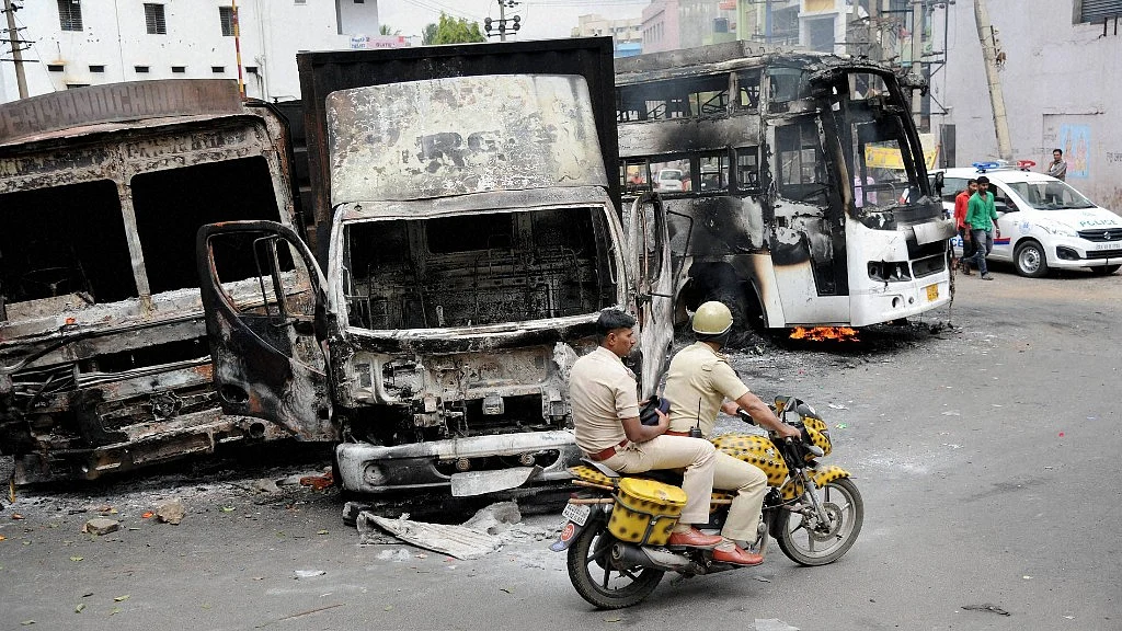Charred remains of the vehicles in Bengaluru on Tuesday, a day after they were torched by pro-Kannada activists during violent protests over Cauvery water dispute. (Photo: PTI)