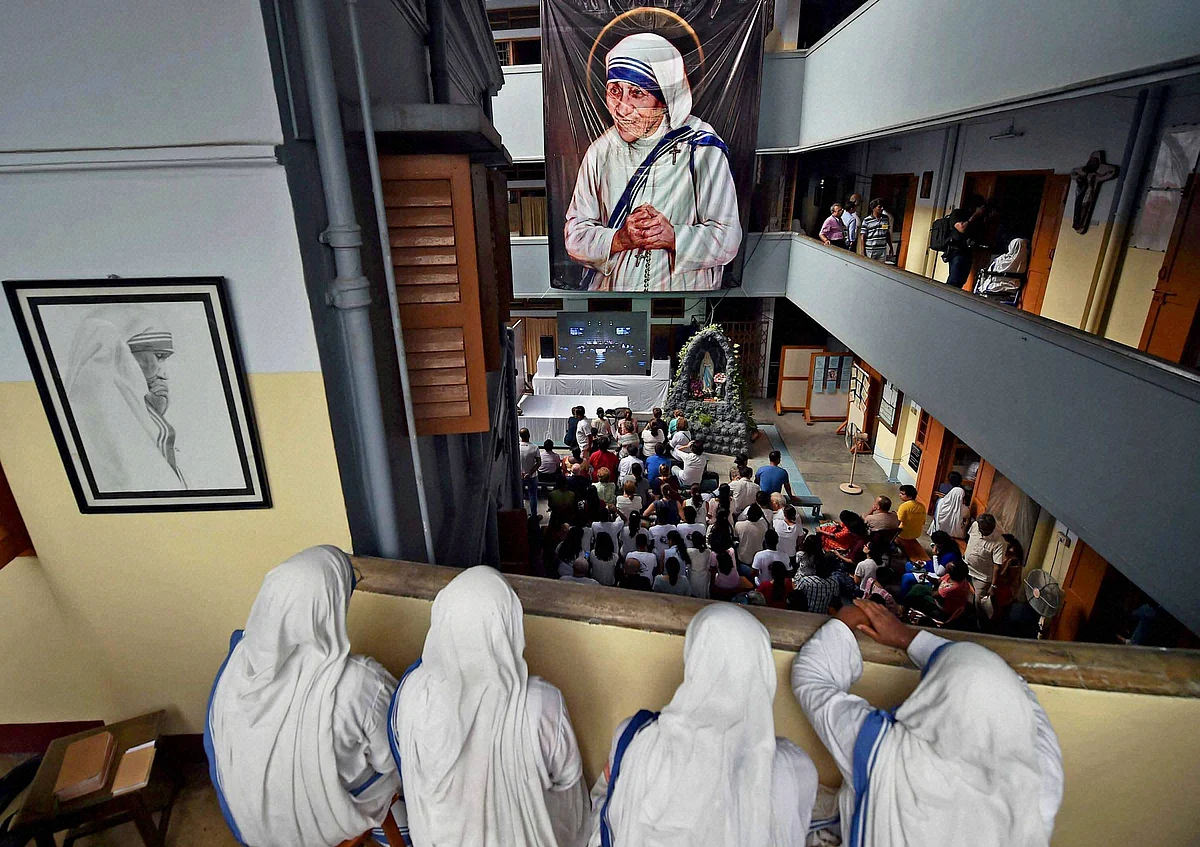 Nuns of Missionaries of charity watch live telecast of canonisation ceremony of Mother Teresa from the balcony of Missionaries of Charity. (Photo: PTI)