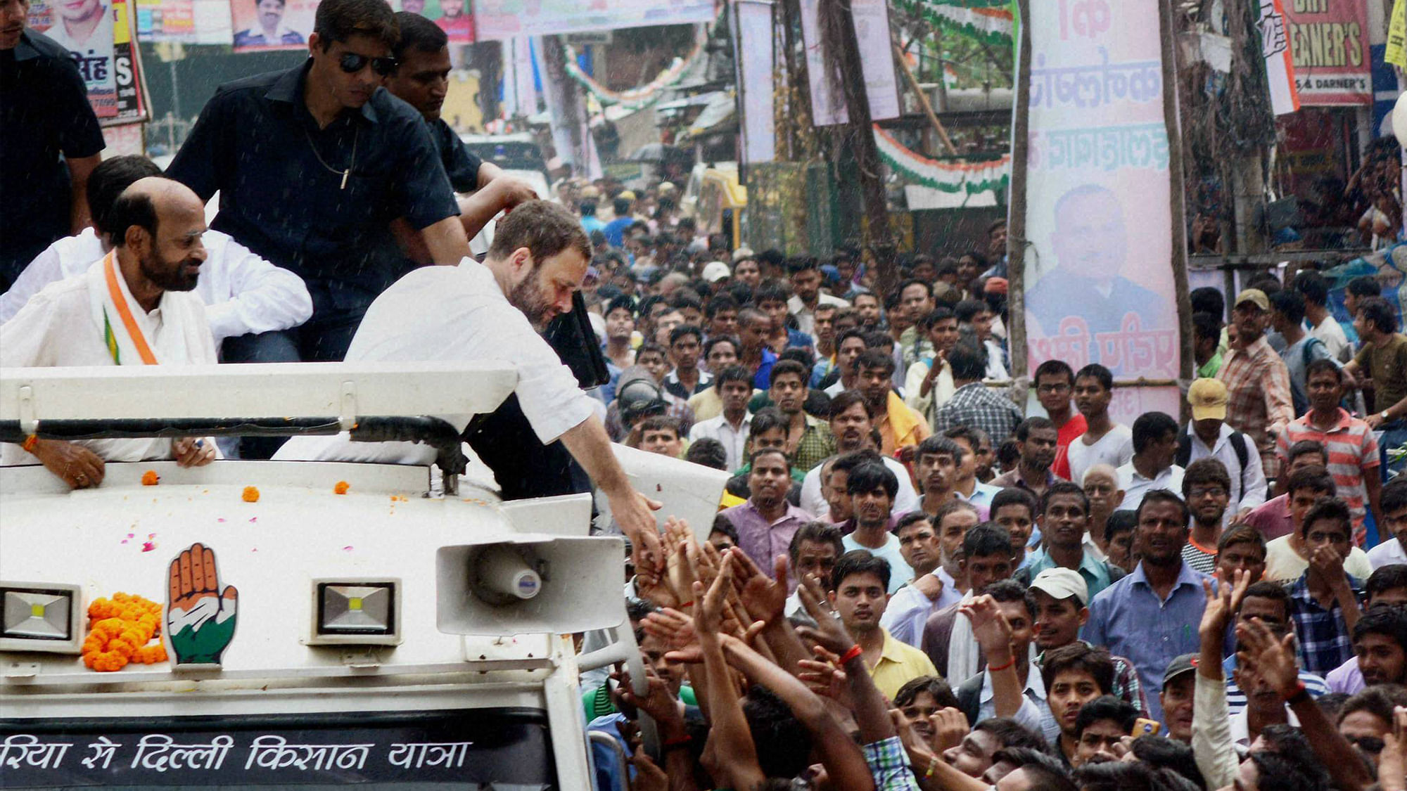 Congress Vice President Rahul Gandhi shaking hands with supporters at a road show during his Kisan Yatra in Allahabad on Thursday. (Photo: PTI)