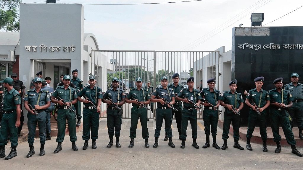 Bangladeshi security personnel stand guard in front of Kashimpur Central Jail where Mir Quashem Ali, a senior leader of the main Islamist party Jamaat-e-Islami, was being held. (Photo: AP)