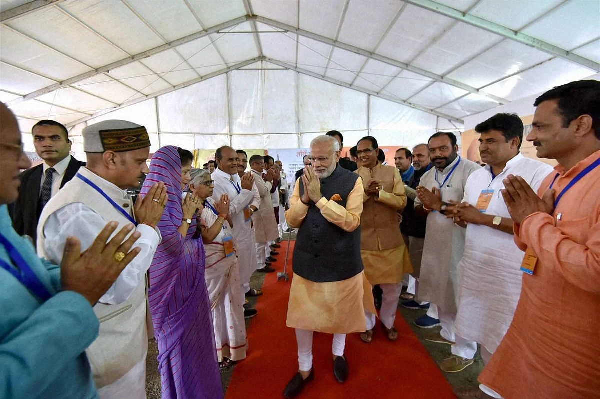Narendra Modi with Shivraj Singh Chauhan in Bhopal on Friday. (Photo: PTI)