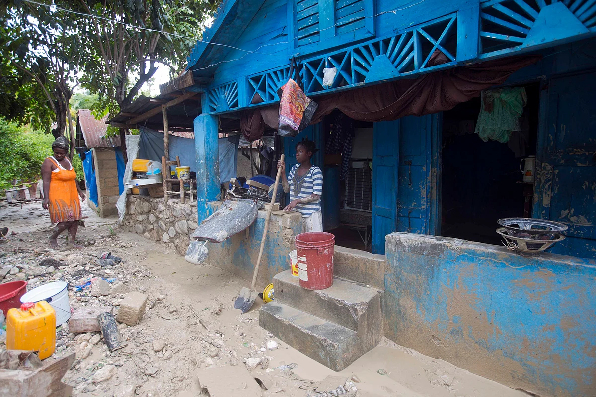 People in Haiti pick up after Hurricane Matthew. (Photo: AP)
