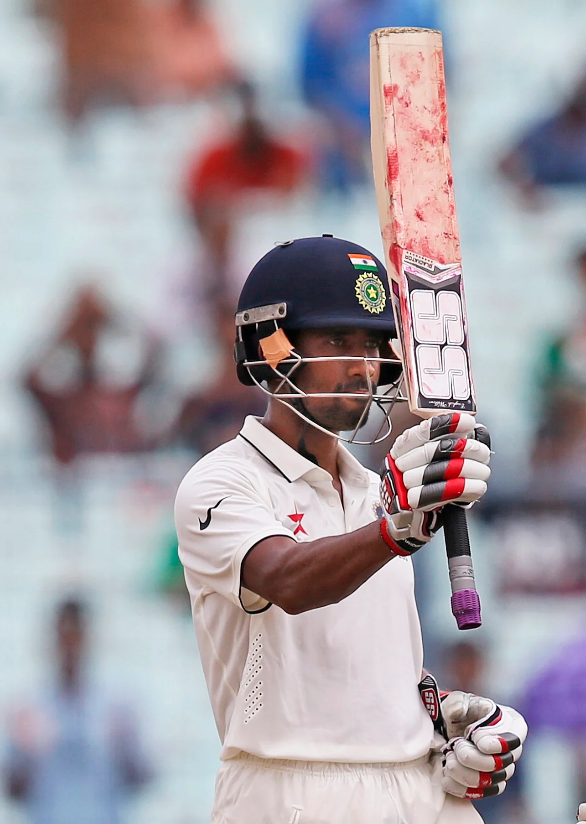 Wriddhiman Saha raises his bat after scoring a half century against New Zealand in the second test match at Kolkata. (Photo: AP)