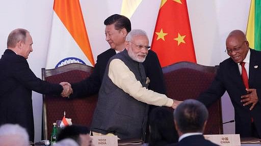 PM Modi (center front) shakes hand with South African President Jacob Zuma, as Russian President Vladimir Putin (left) shakes hand with Chinese President Xi Jinping at the end of the BRICS summit in Goa, India, Sunday, 2016.  (AP Photo/Manish Swarup)