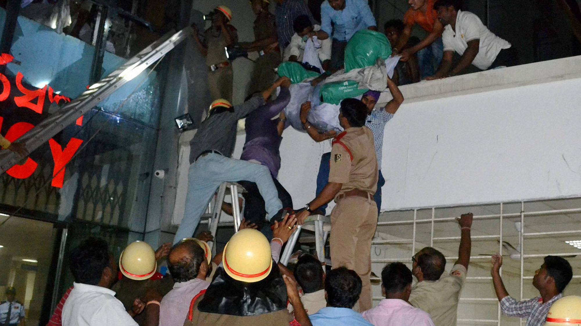 Rescue personnel bring down dead bodies of patients at SUM Hospital on Tuesday. (Photo Courtesy: PTI)