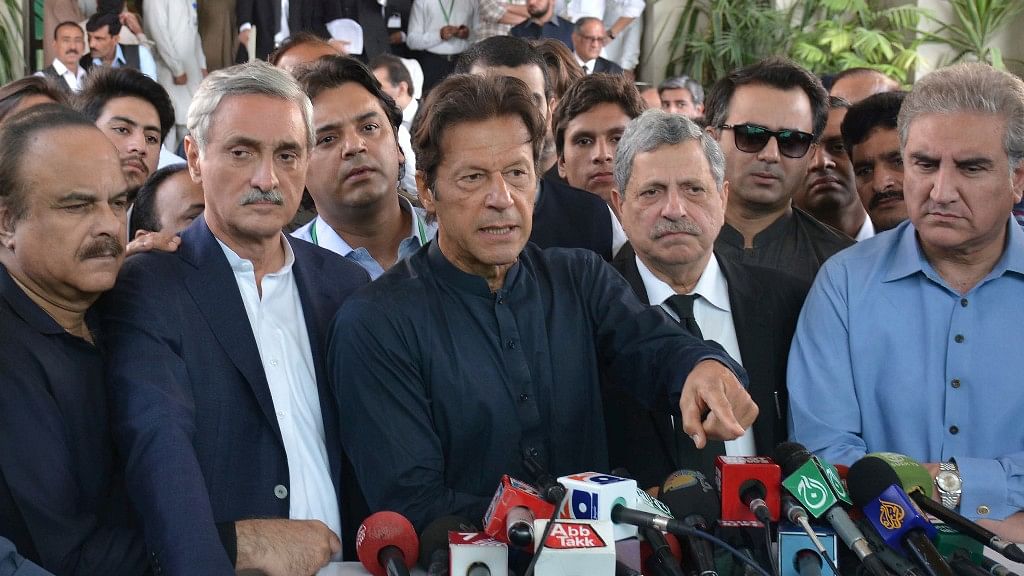 Pakistani Prime Minister Imran Khan (centre) talks to journalists outside the Supreme Court in Islamabad.