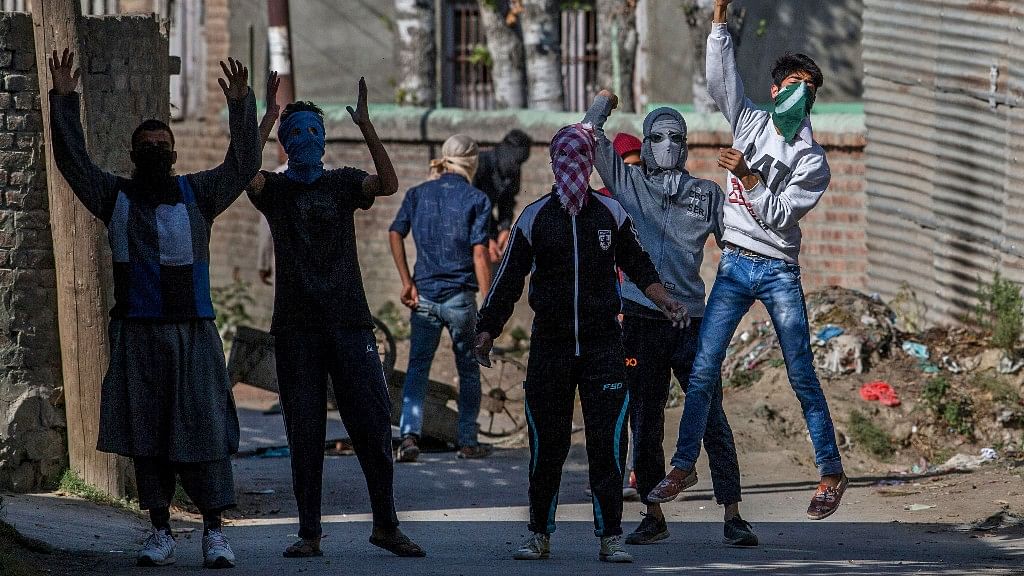 

Masked Kashmiri protesters shout pro-freedom slogans during a protest in Srinagar, India Controlled Kashmir. (Photo: AP)