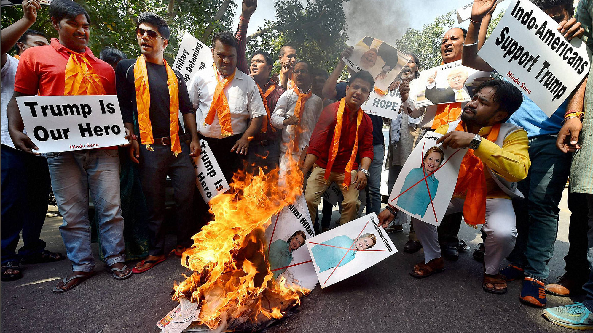 Activists of Hindu Sena set a portrait of U.S. presidential candidate Hillary Clinton on fire during a protest at Jantar Mantar in New Delhi on Tuesday. (Photo: PTI)