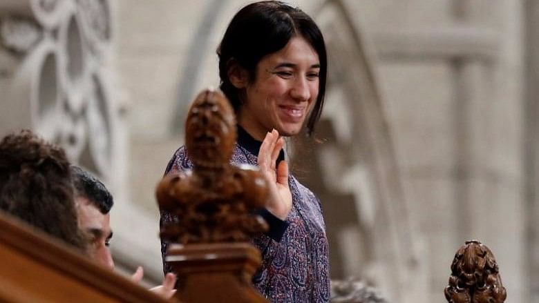Nadia Murad Basee Taha, United Nations Goodwill Ambassador for the Dignity of Survivors of Human Trafficking, waves while being recognised by the Speaker in the House of Commons on Parliament Hill in Ottawa, Canada, 25 October 2016. (Photo: Reuters)