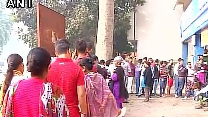 

People wait in long queues for ATMs to open in Delhi. (Photo:Twitter/ANI)