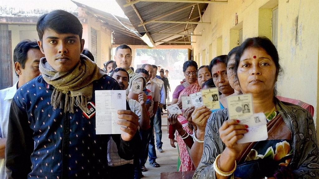

Voters show their voter identity cards as they wait in queues to cast their vote during the assembly by polls at Barjala in Agartala, 19 November, 2016. (Photo: PTI)