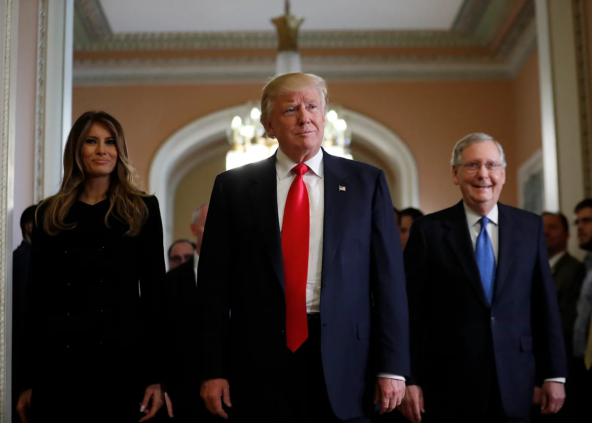 President Donald Trump and his wife Melania walk with Senate Majority Leader Mitch McConnell on Capitol Hill. 